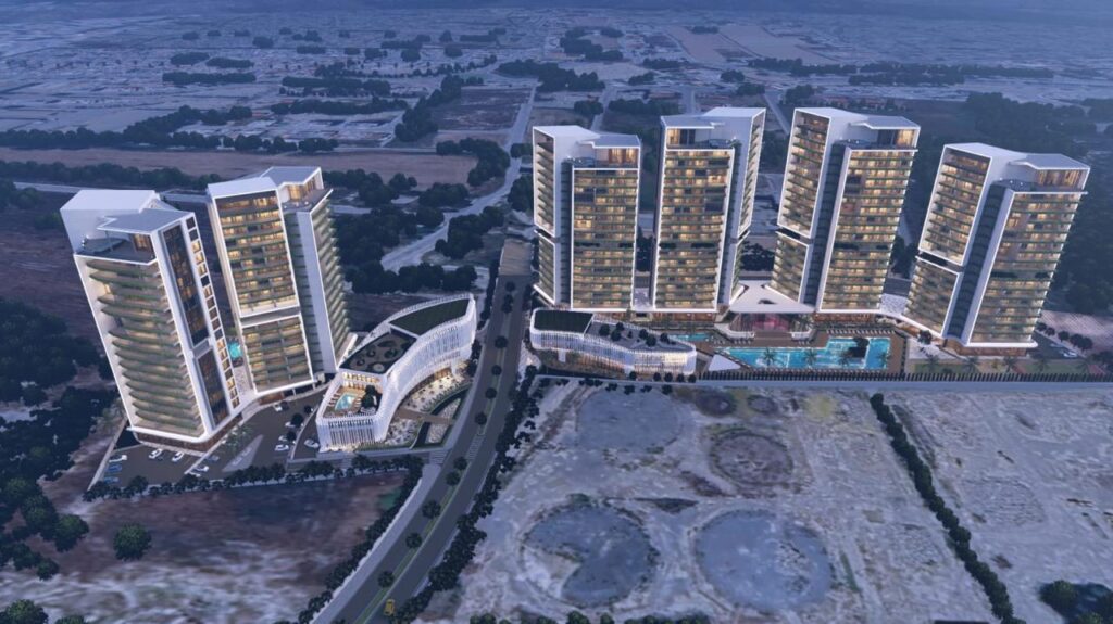 Aerial view of a modern residential and commercial development project in Cyprus featuring multiple high-rise buildings and luxury amenities